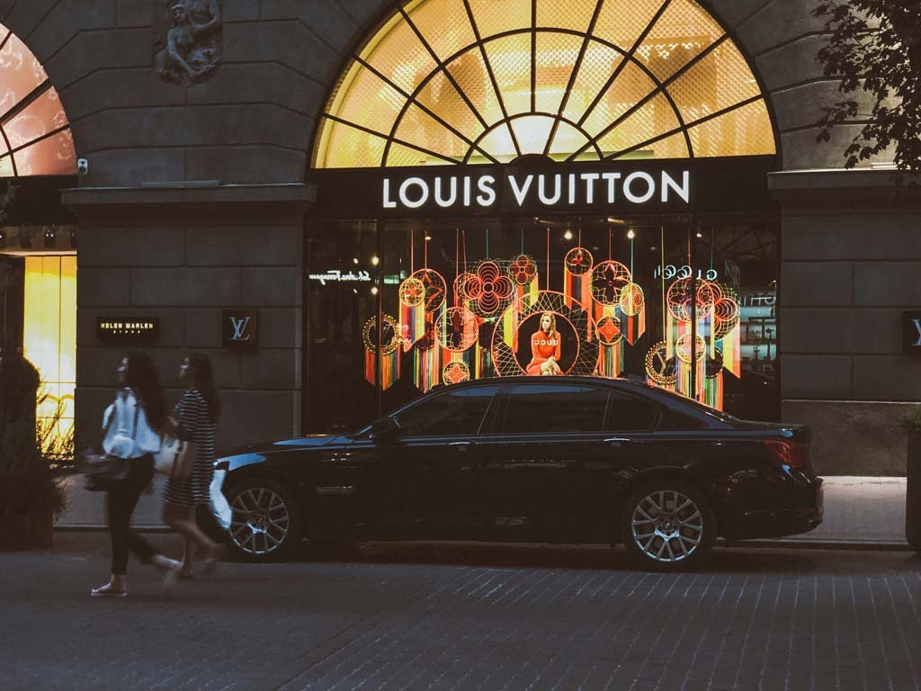 luxury car in front of store front